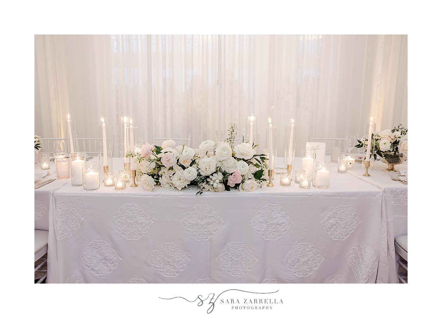Belle Mer Island House wedding reception sweetheart table with ivory candles 