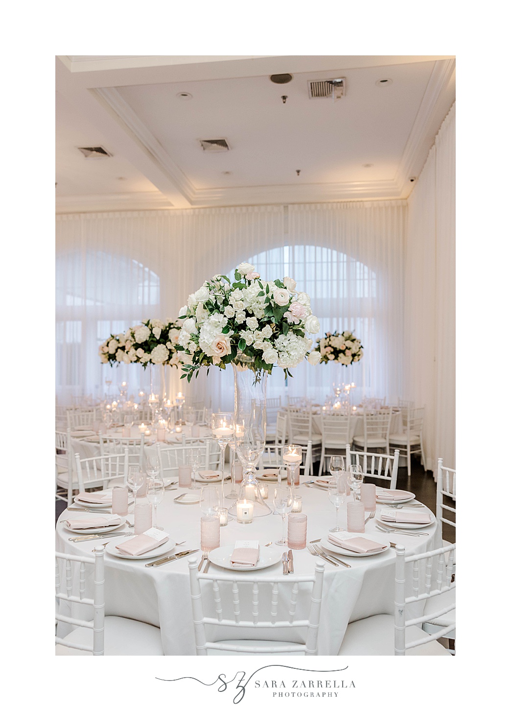 tall floral centerpieces with white flowers at Belle Mer Island House
