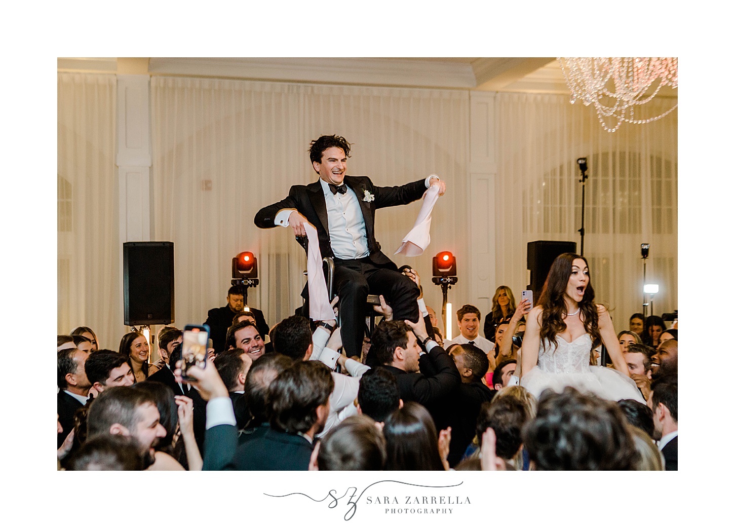 guests lift up groom during horah dance 