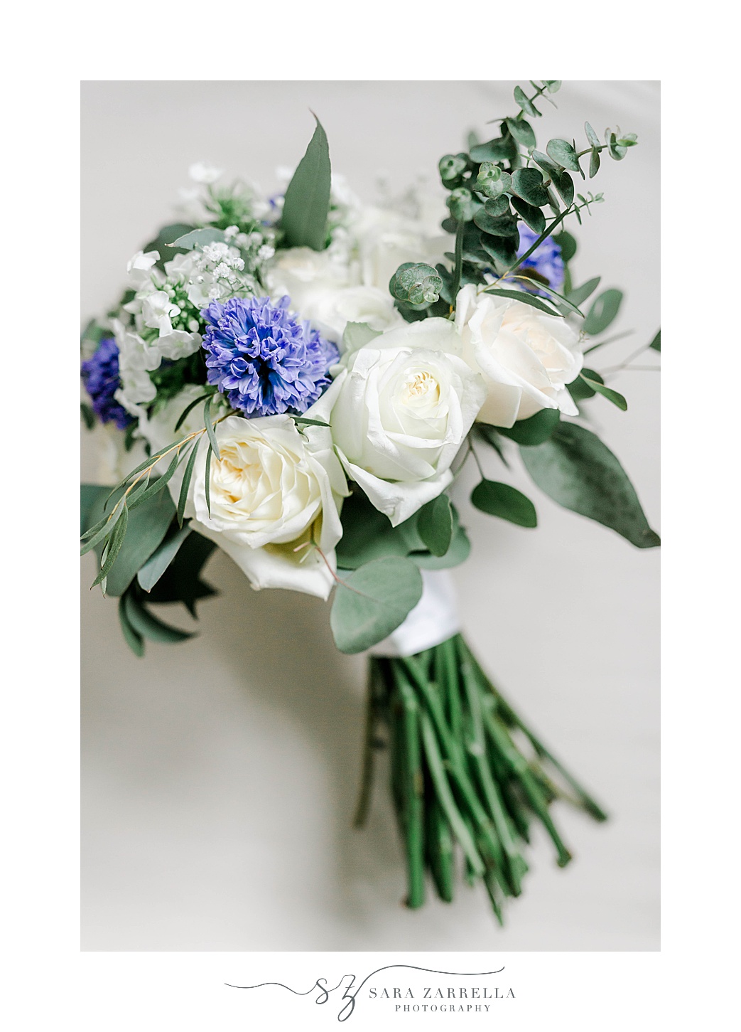 wedding bouquet with white roses and purple flowers 