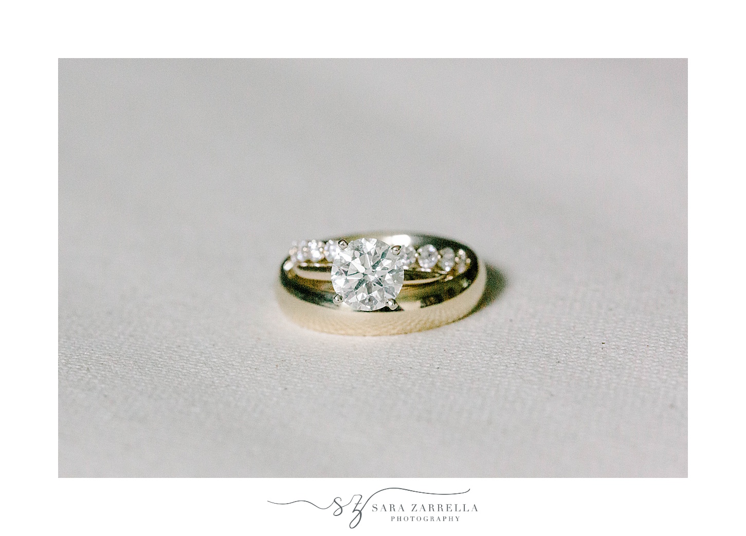 gold wedding bands stacked on ivory backdrop