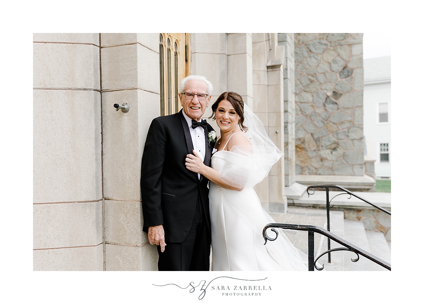 bride and grandfather hug on steps of Our Lady of the Rosary