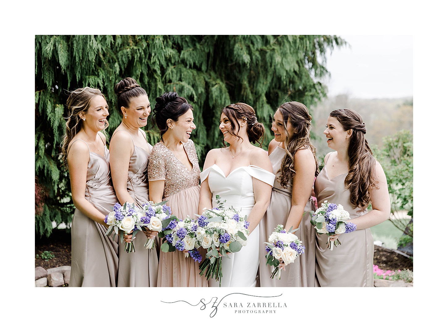 bride and bridesmaids hold bouquets in front of them in Rhode Island