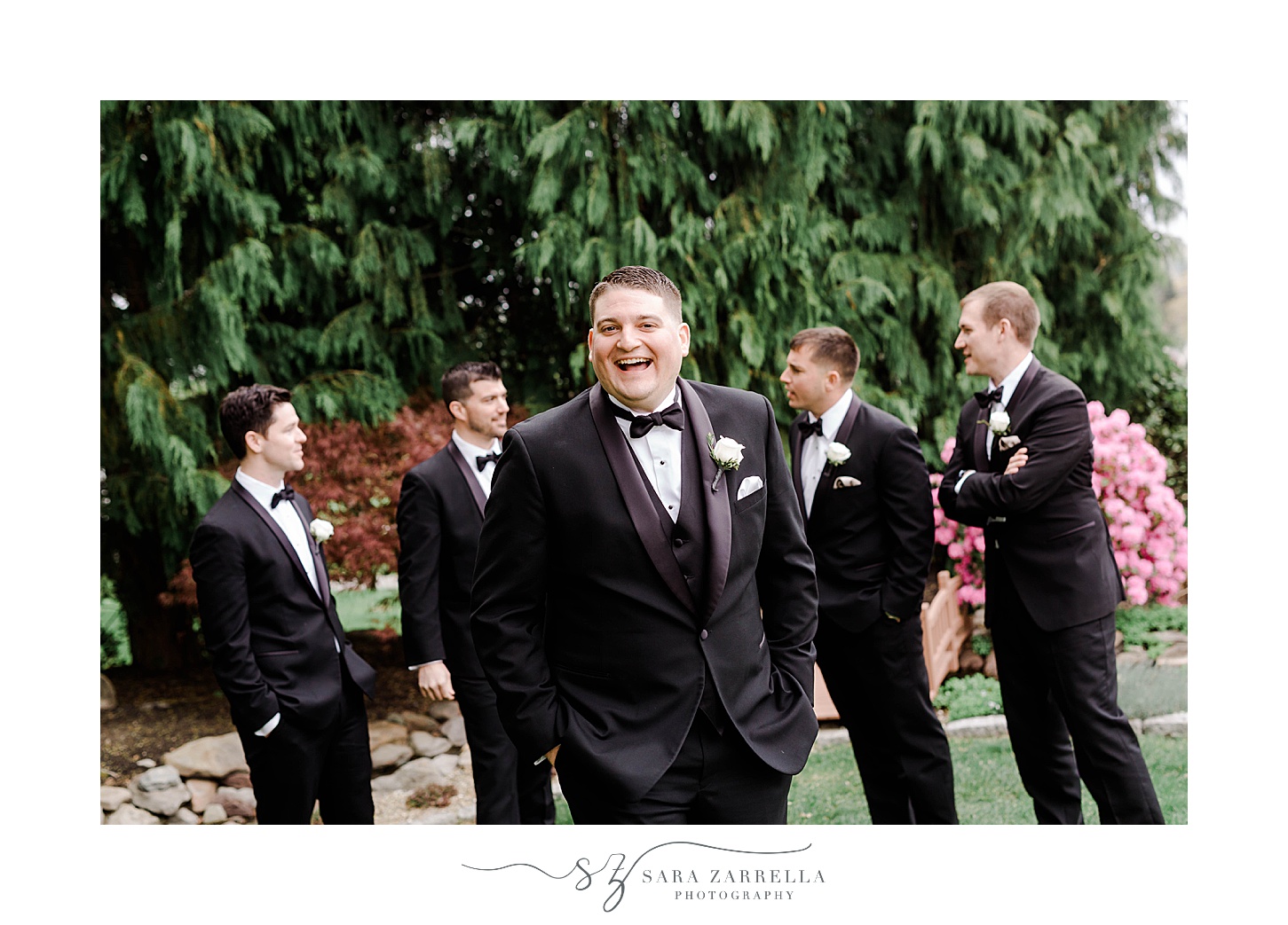 groom smiles in classic suits outside Our Lady of the Rosary