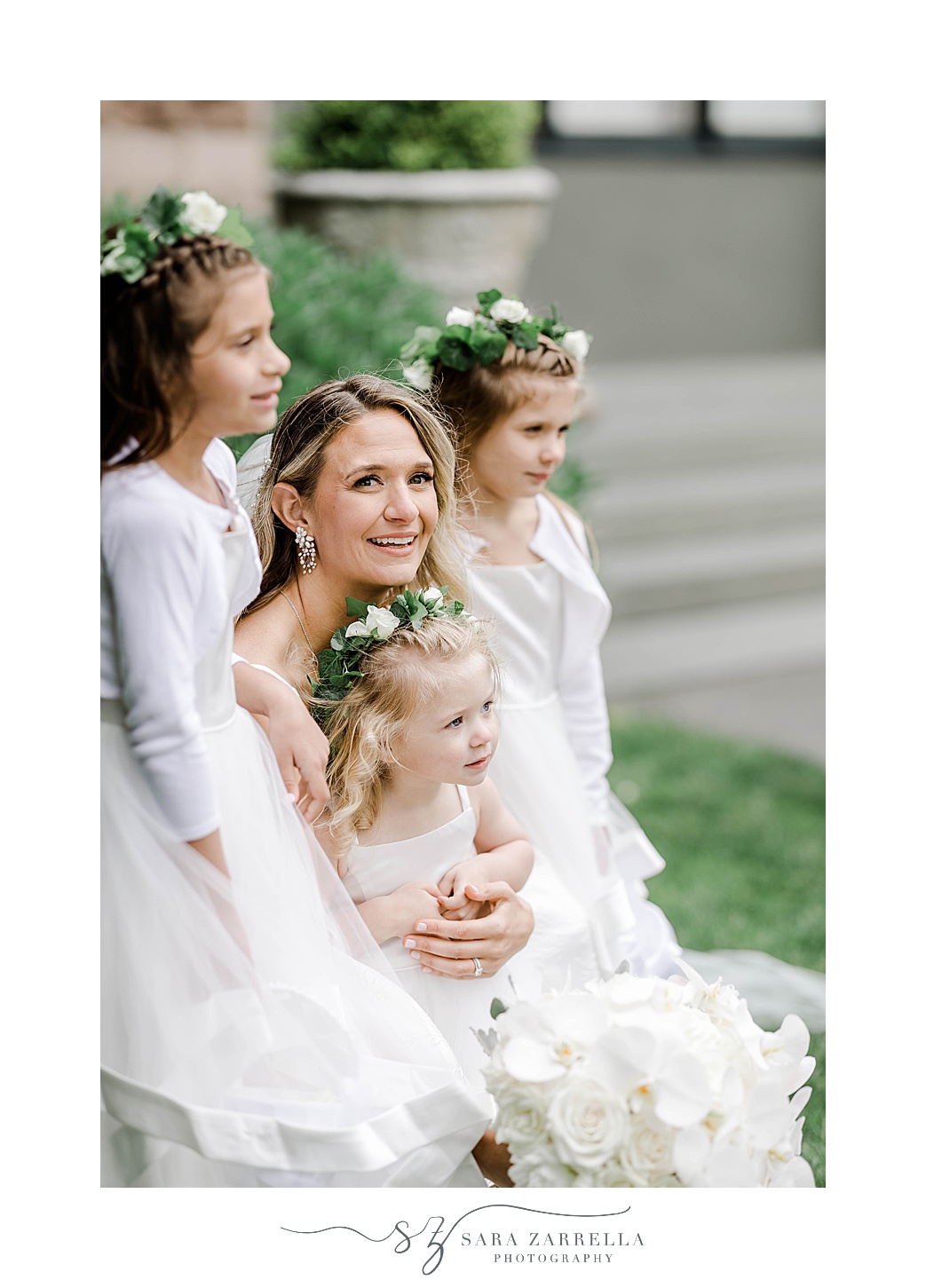 bride Neels with flower girls in white dresses with flower crowns 