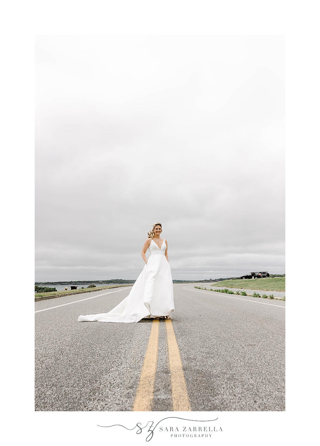 bride poses on road in Newport RI near OceanCliff Hotel