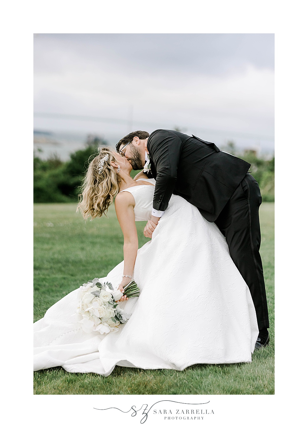 groom dips bride kissing her on Newport RI wedding day