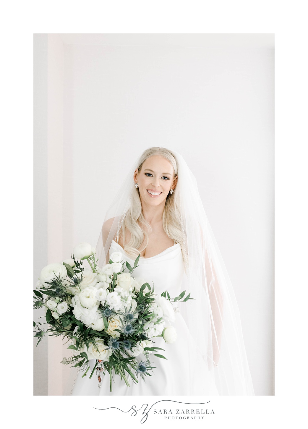 bride holds bouquet of white and green flowers at Omni Providence Hotel
