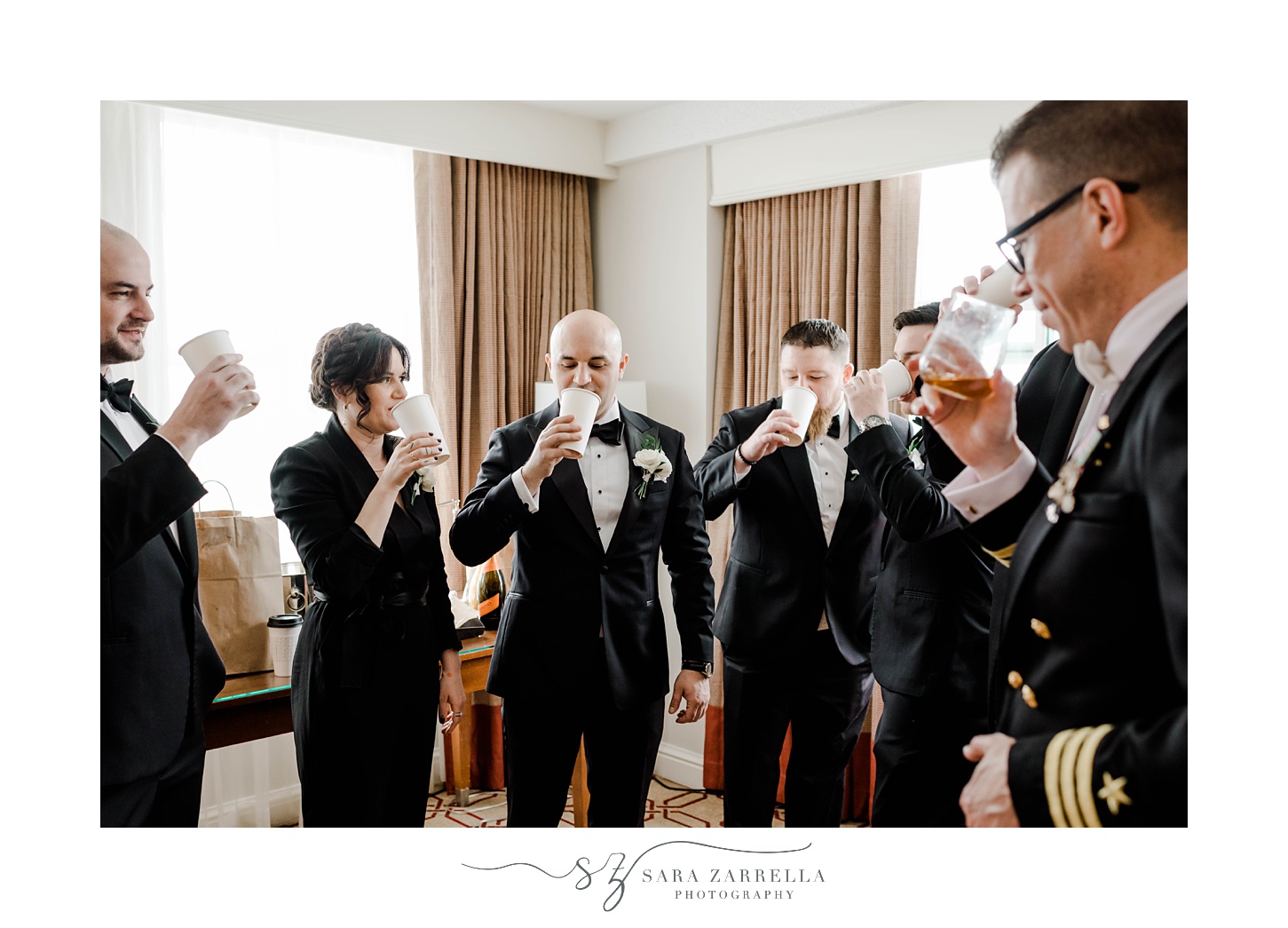 groom and groomsmen have a drink inside the Omni Providence Hotel