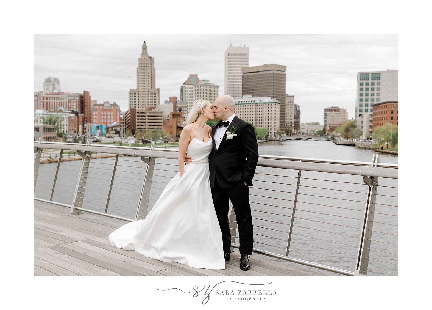newlyweds kiss on the Providence pedestrian bridge in Rhode Island