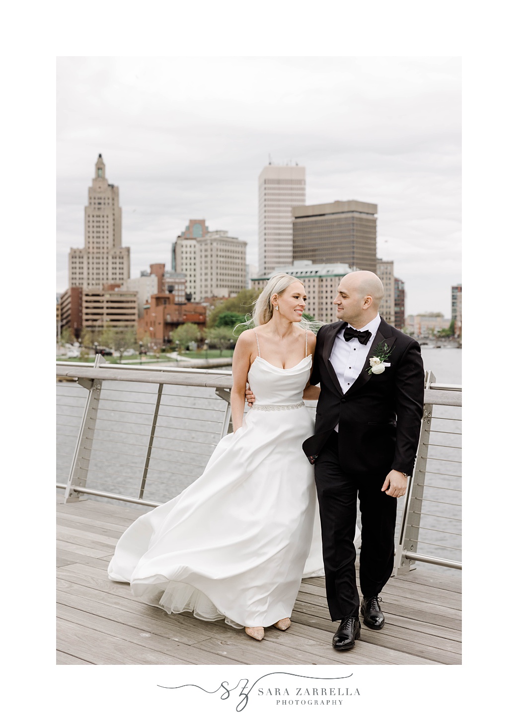 bride and groom walk on the Providence pedestrian bridge
