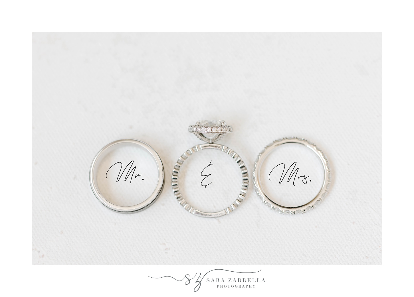 wedding rings lay on ivory background and Mr and Mrs font