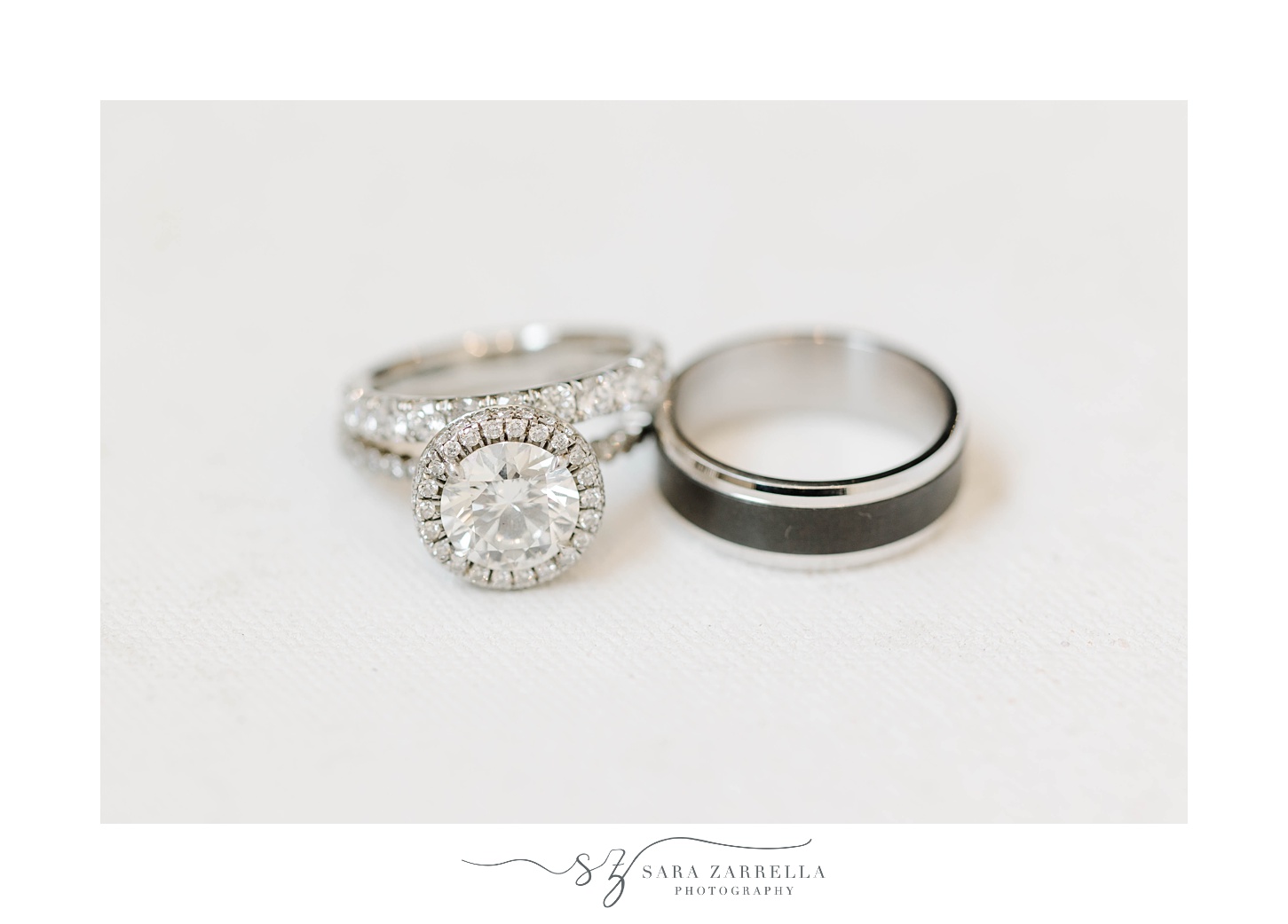 diamond ring lays next to groom's wedding ring
