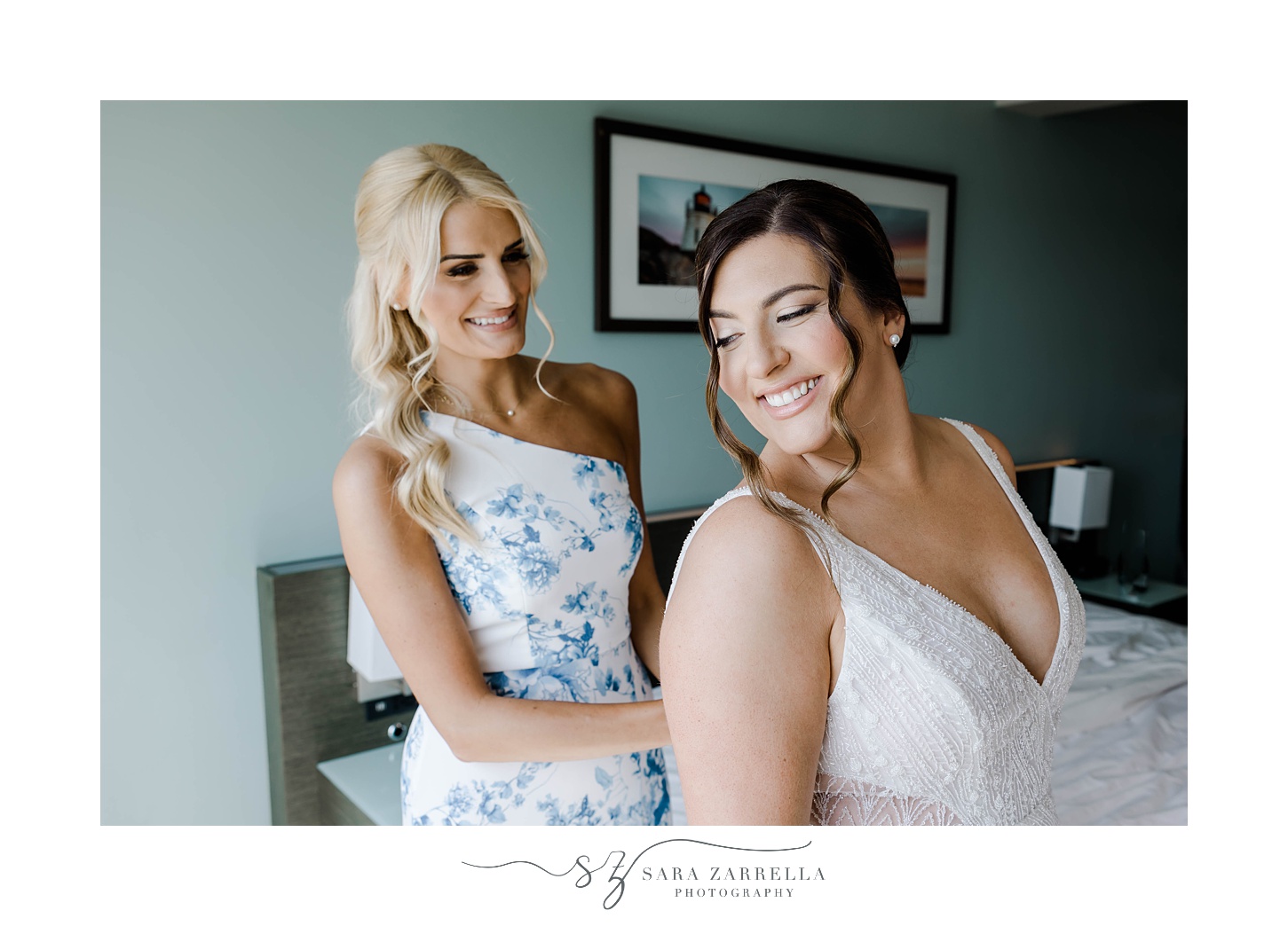 bride smiles over shoulder at mom in white and blue dress