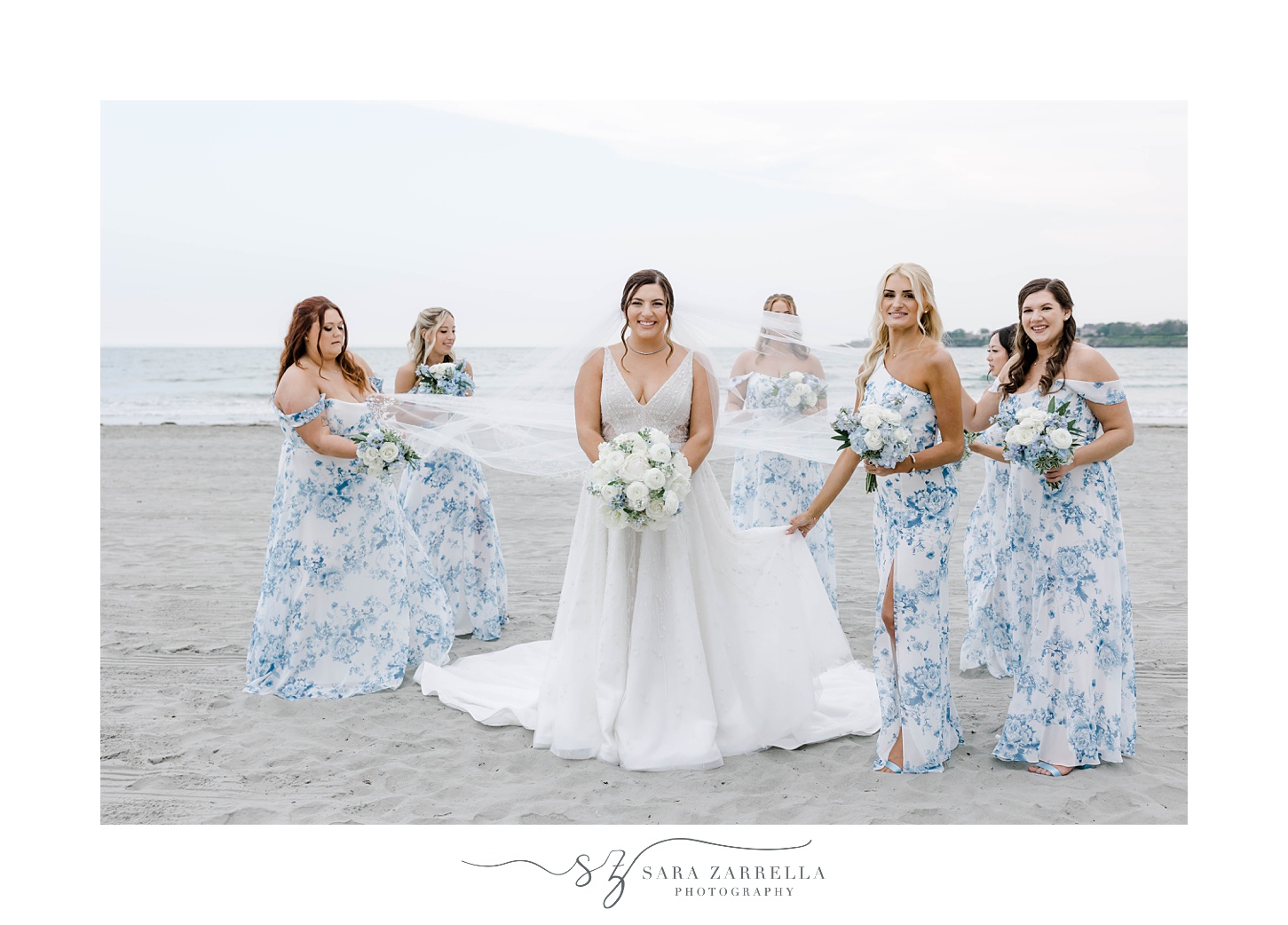 bridesmaids help bride with veil on Newport Beach