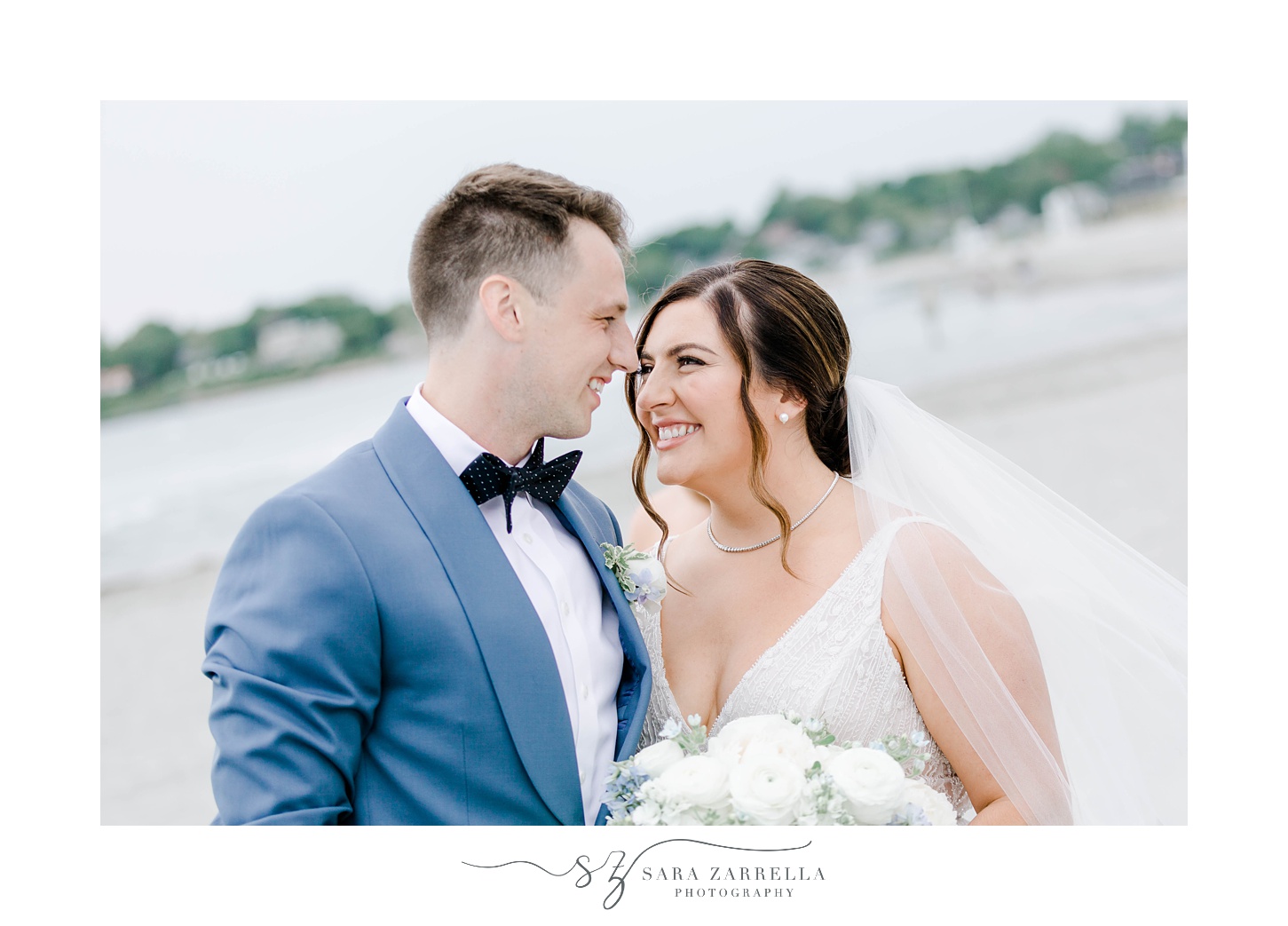 bride and groom smile at each other on beach in Newport RI