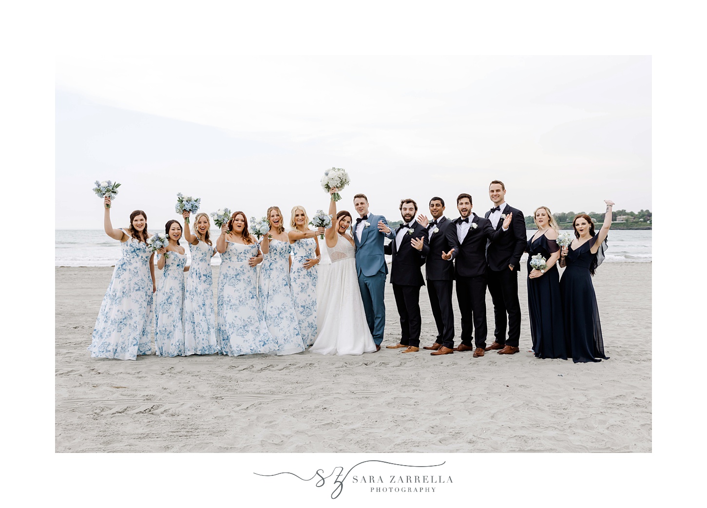 newlyweds cheer with wedding party standing on Newport Beach