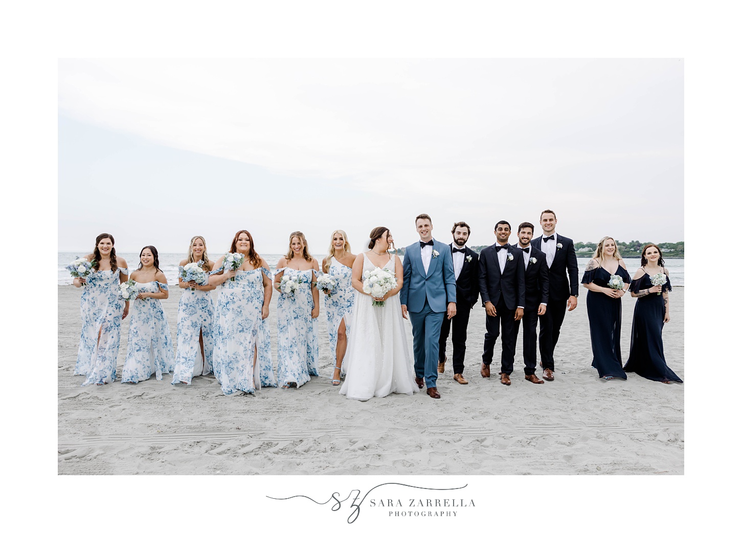 bride and groom walk with wedding party on Newport Beach