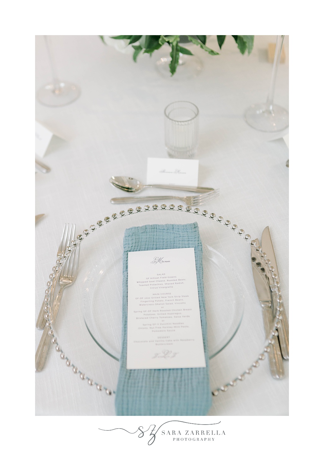 place setting with silverware and blue napkin