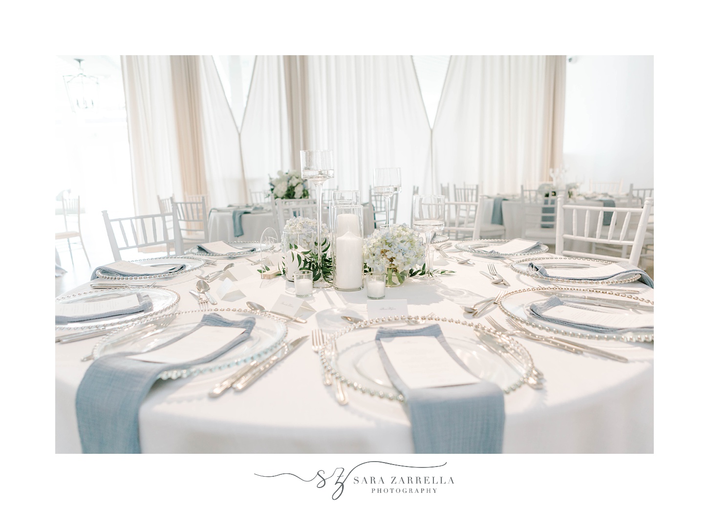 elegant Newport Beach House wedding reception place setting with blue napkins