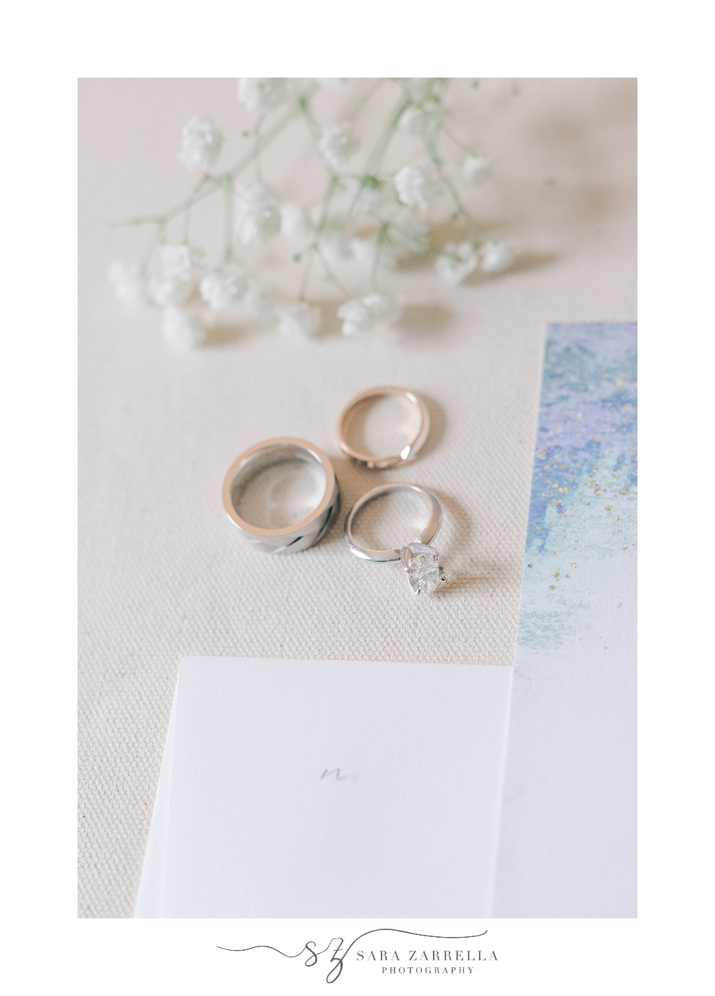 wedding rings near blue and white stationery set for summer OceanCliff Hotel wedding