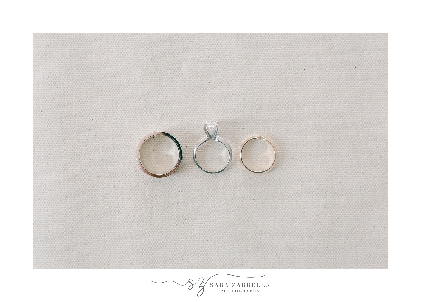wedding rings lay on ivory backdrop