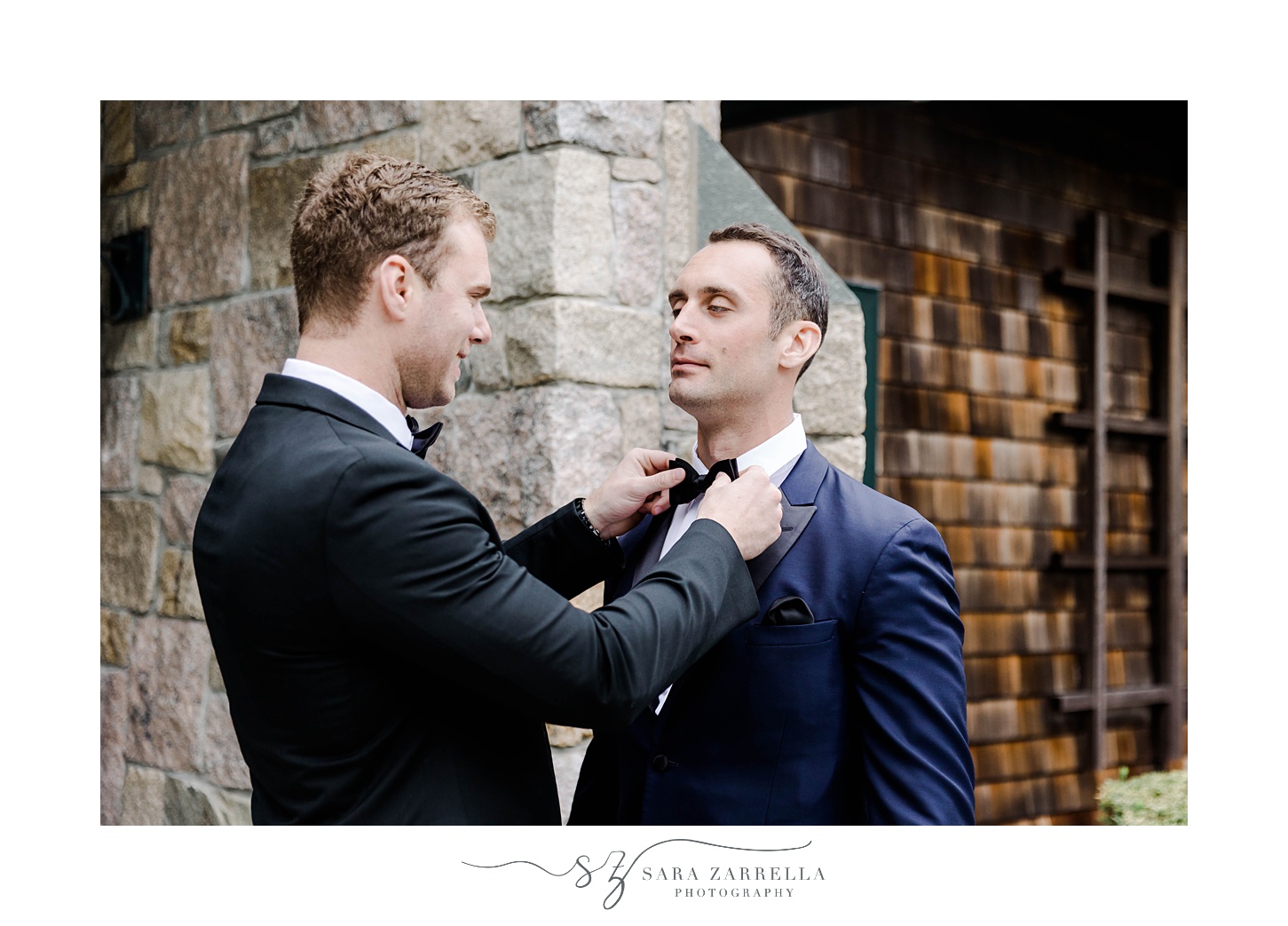 groomsman adjusts tie for groom in Newport RI