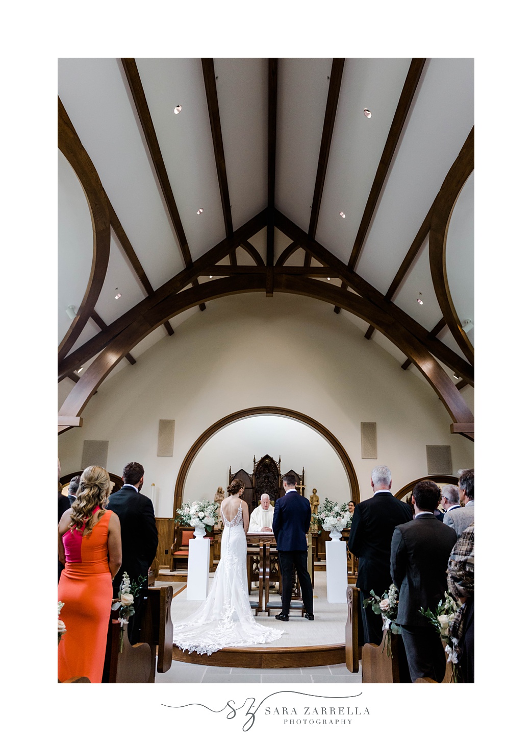 bride and groom stands together during wedding ceremony at Our Lady of Mercy Chapel at Salve Regina University