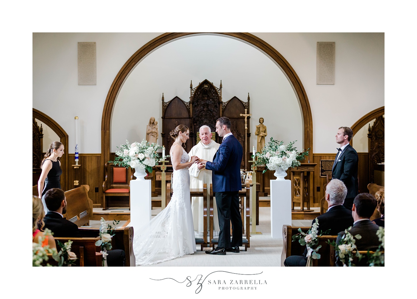 newlyweds exchange rings during wedding ceremony at Our Lady of Mercy Chapel at Salve Regina University