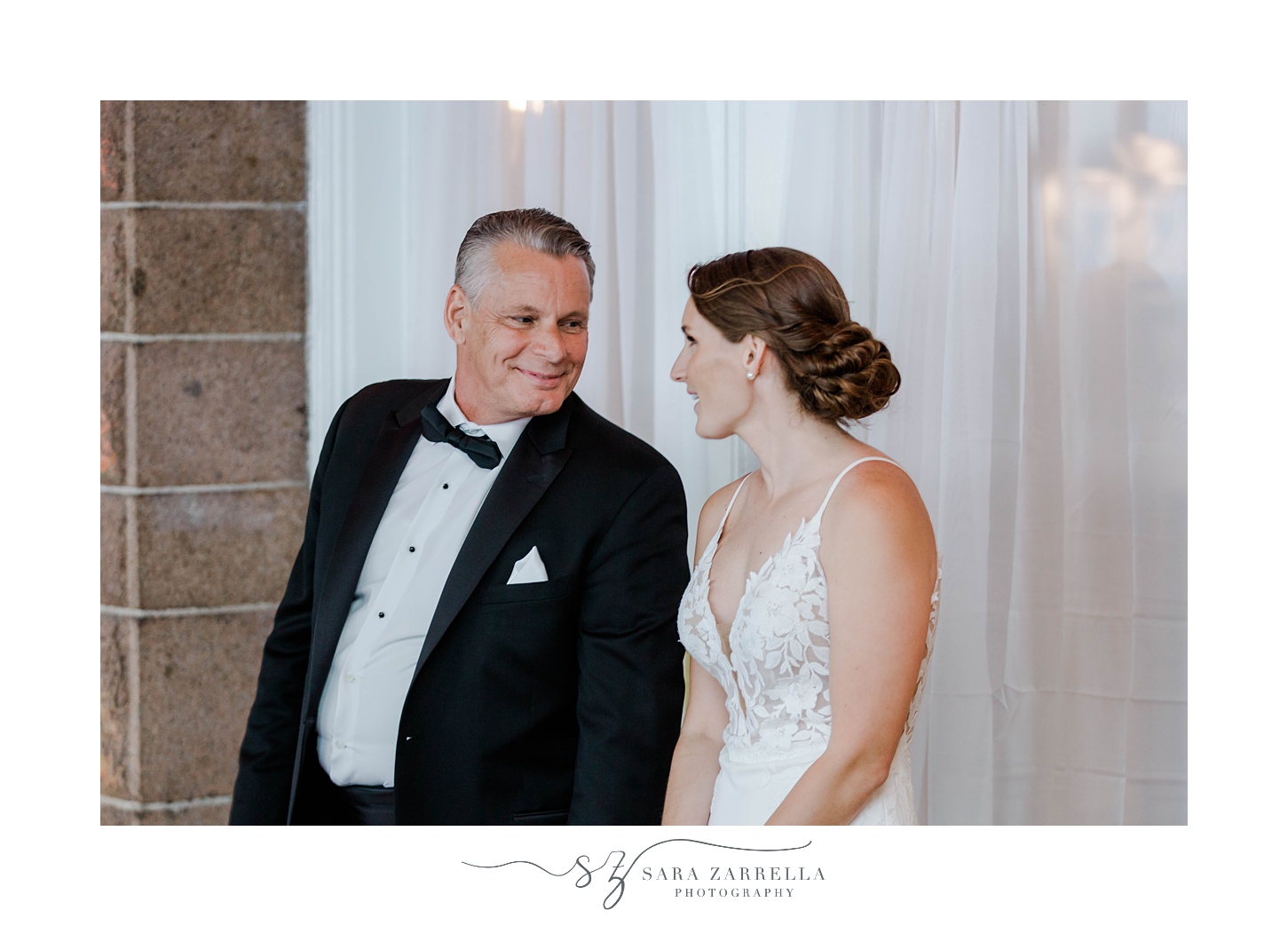 bride smiles at father during Newport RI wedding reception