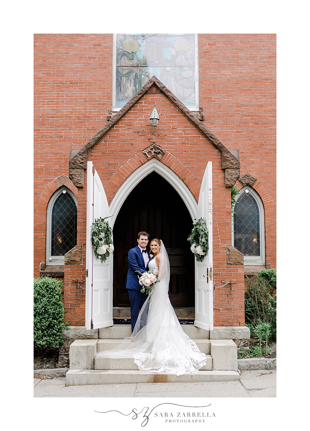 bride and groom stand on steps of Rhode Island church