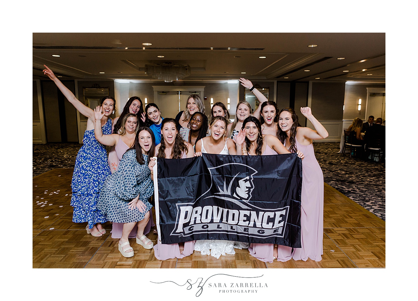 bride poses with guests from Providence College