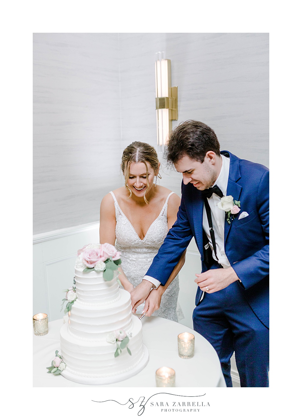 bride and groom cut wedding cake during Newport RI wedding reception