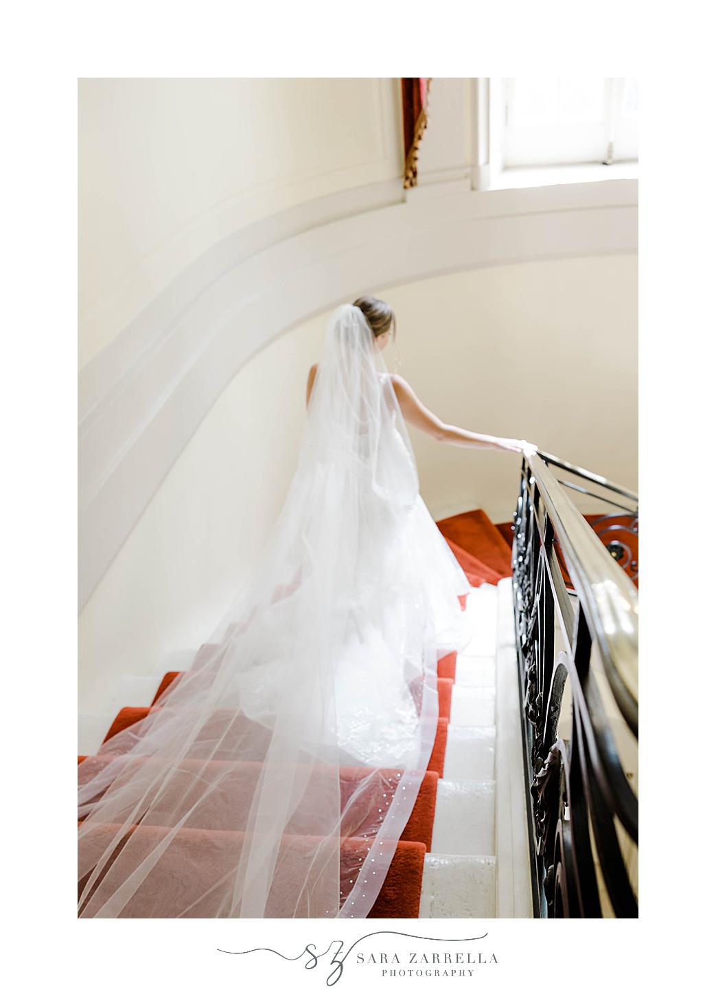 bride walks down staircase inside Glen Manor House