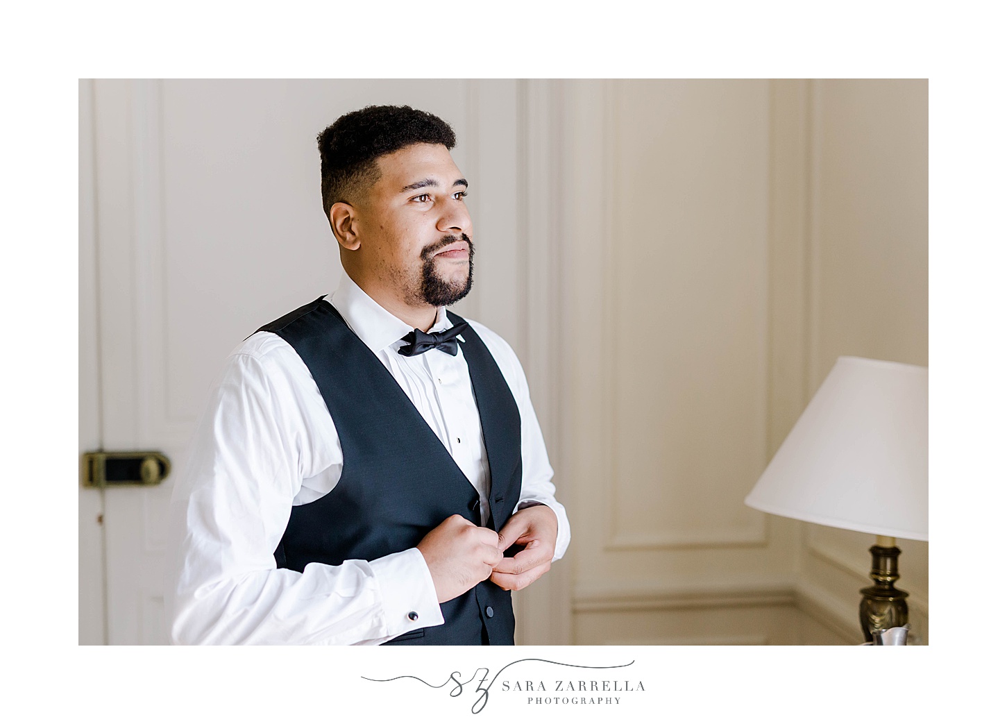 groom adjusts vest before wedding day at Glen Manor House