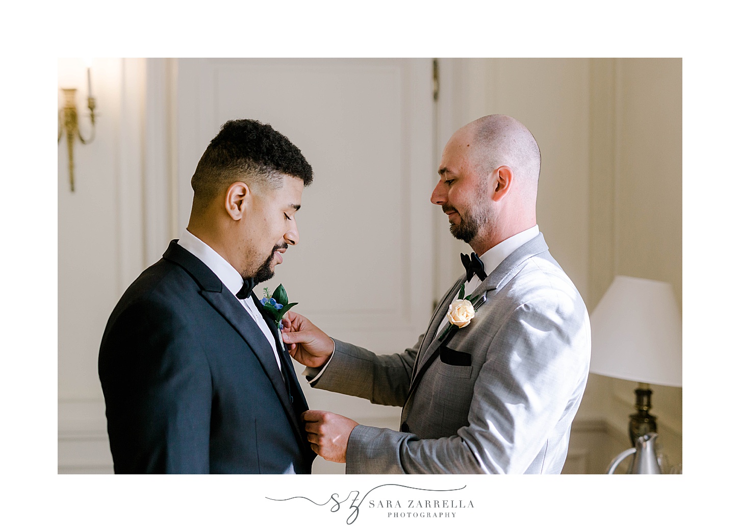 father helps groom adjust boutonnière before RI wedding day 