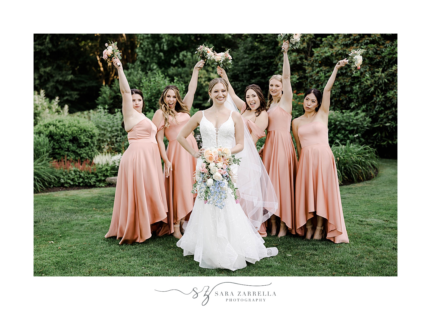 bride and bridesmaids hold bouquets out during photos at Glen Manor House