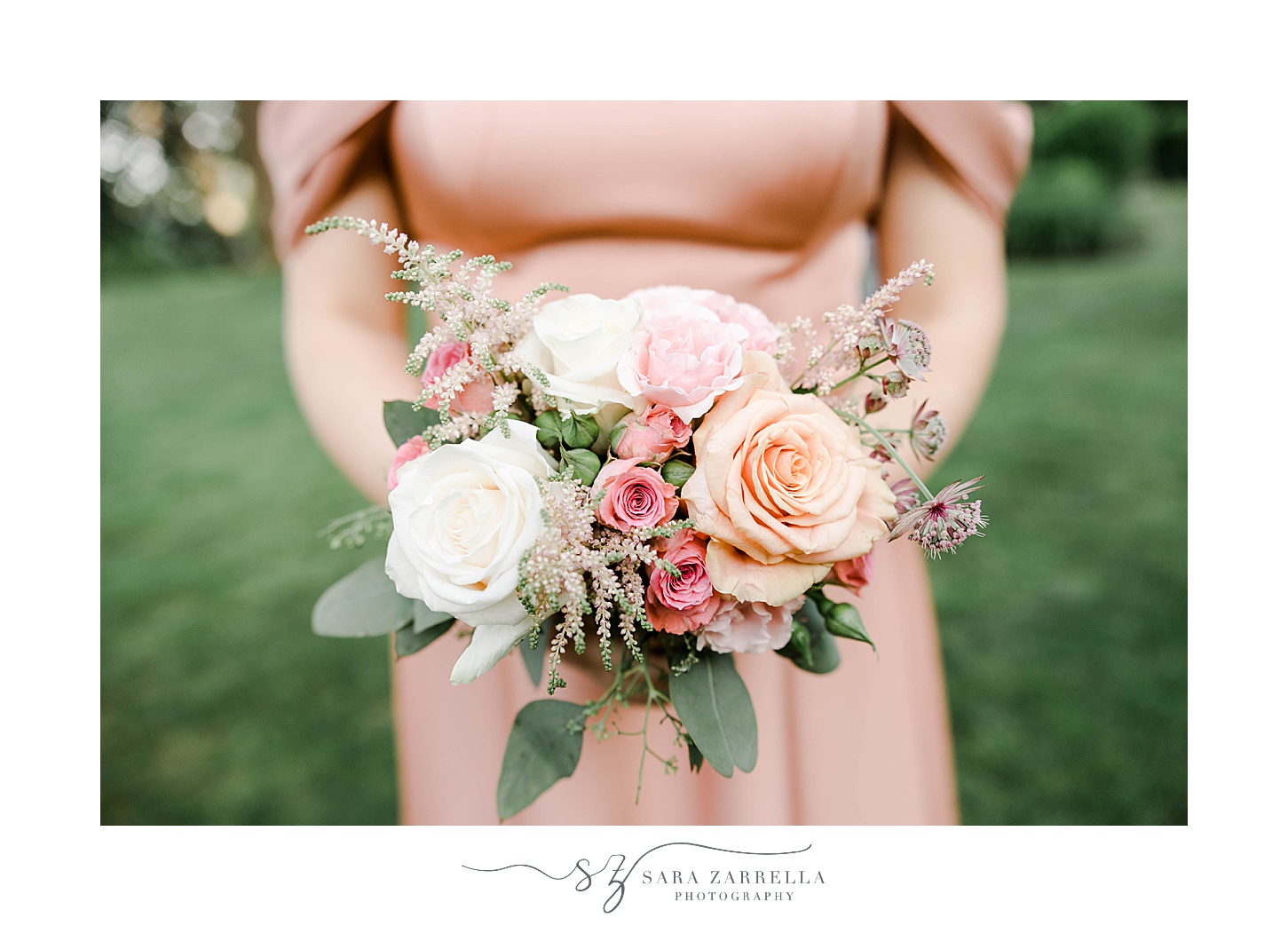 bridesmaid holds bouquet of pink and white flowers during summer wedding