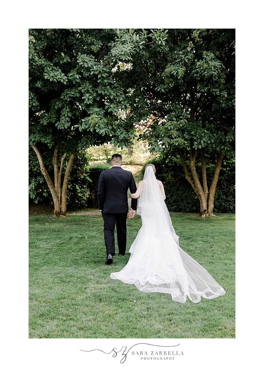 bride and groom hold hands walking on lawn at Glen Manor House