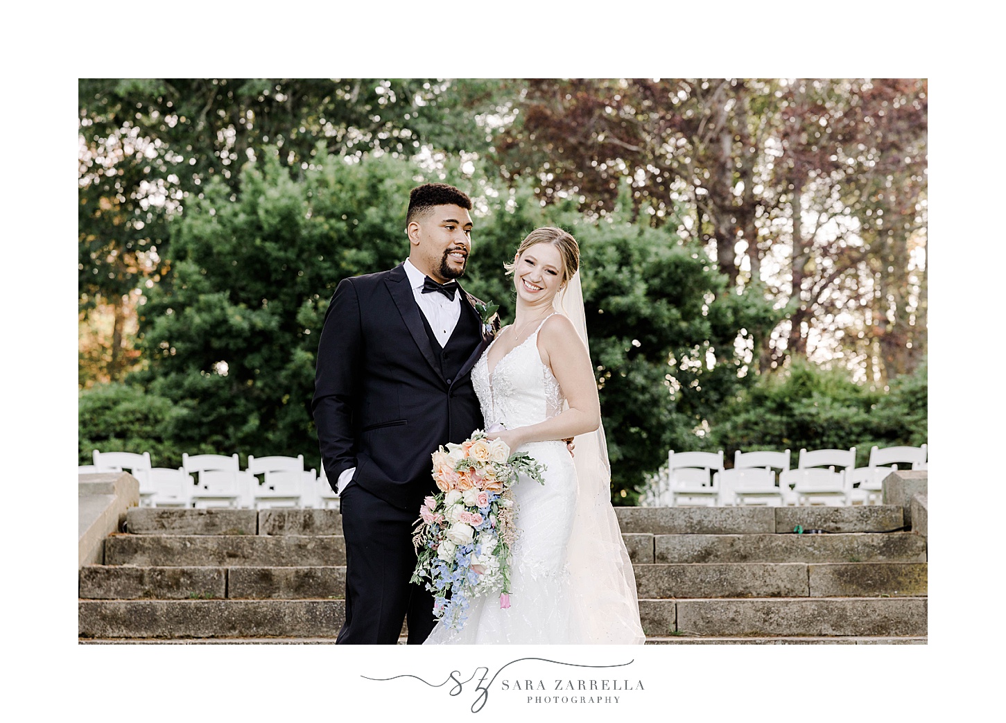 bride and groom hug on steps at Glen Manor House in the summer