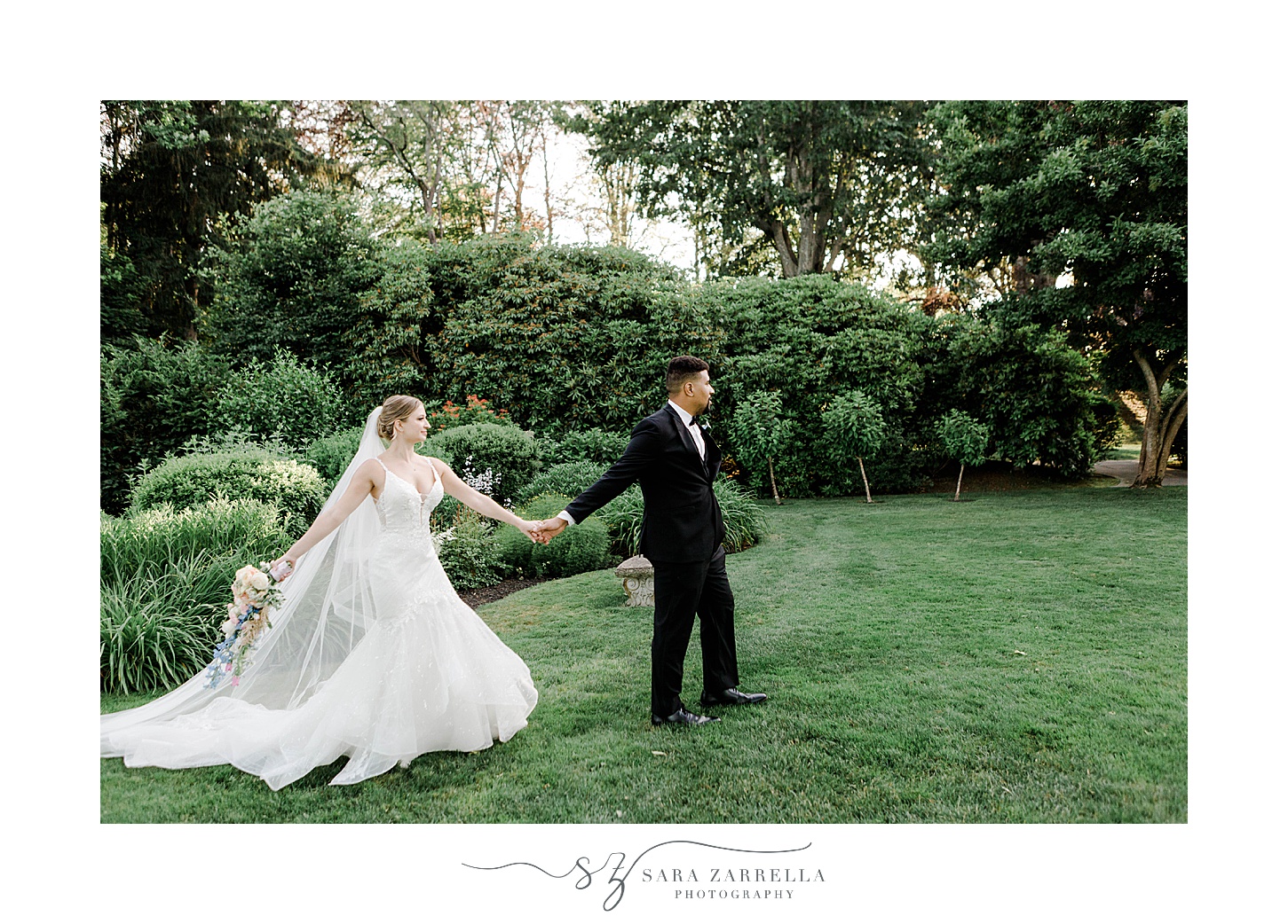 groom holds hands with bride walking on lawn at Glen Manor House