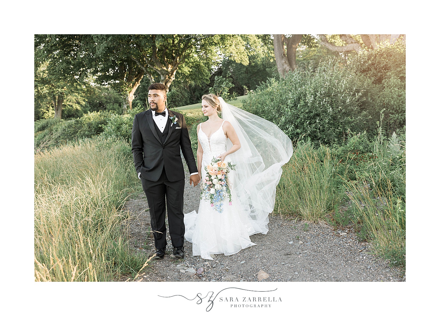 bride and groom walk on lawn at Glen Manor House with veil around shoulders 