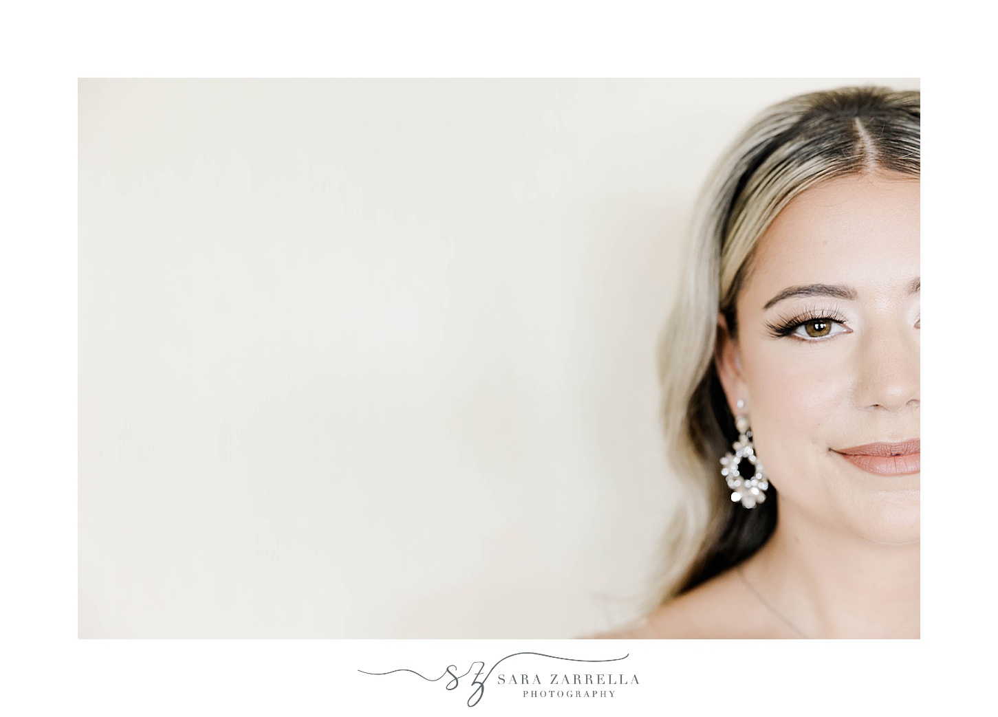 portrait of half of bride's face with diamond earrings