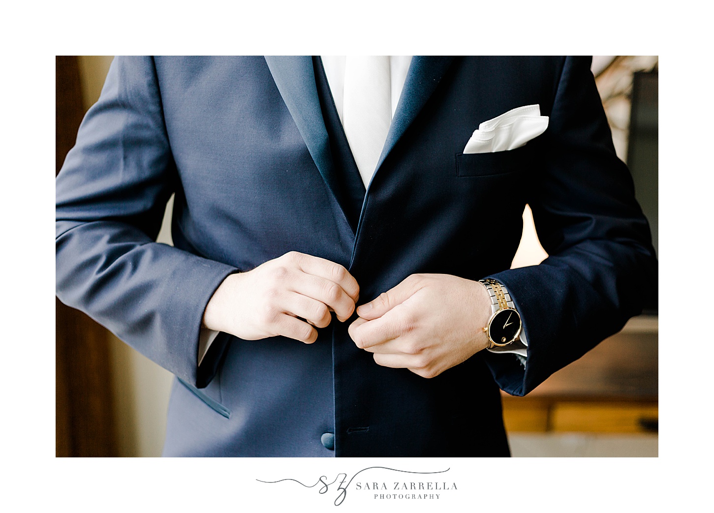 groom buttons up navy suit jacket before Lake of Isles wedding