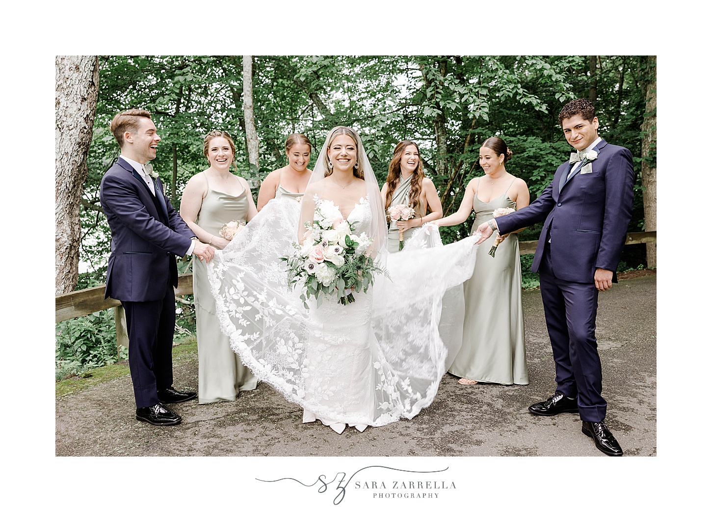 bridal party helps bride with skirt of wedding gown