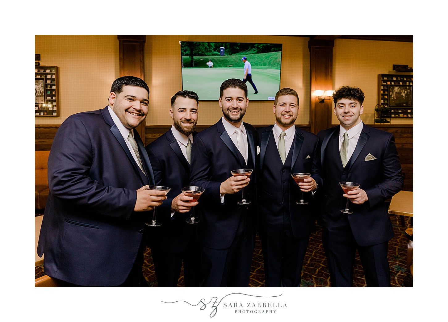 groom stands with groomsmen by bar at Lake of Isles