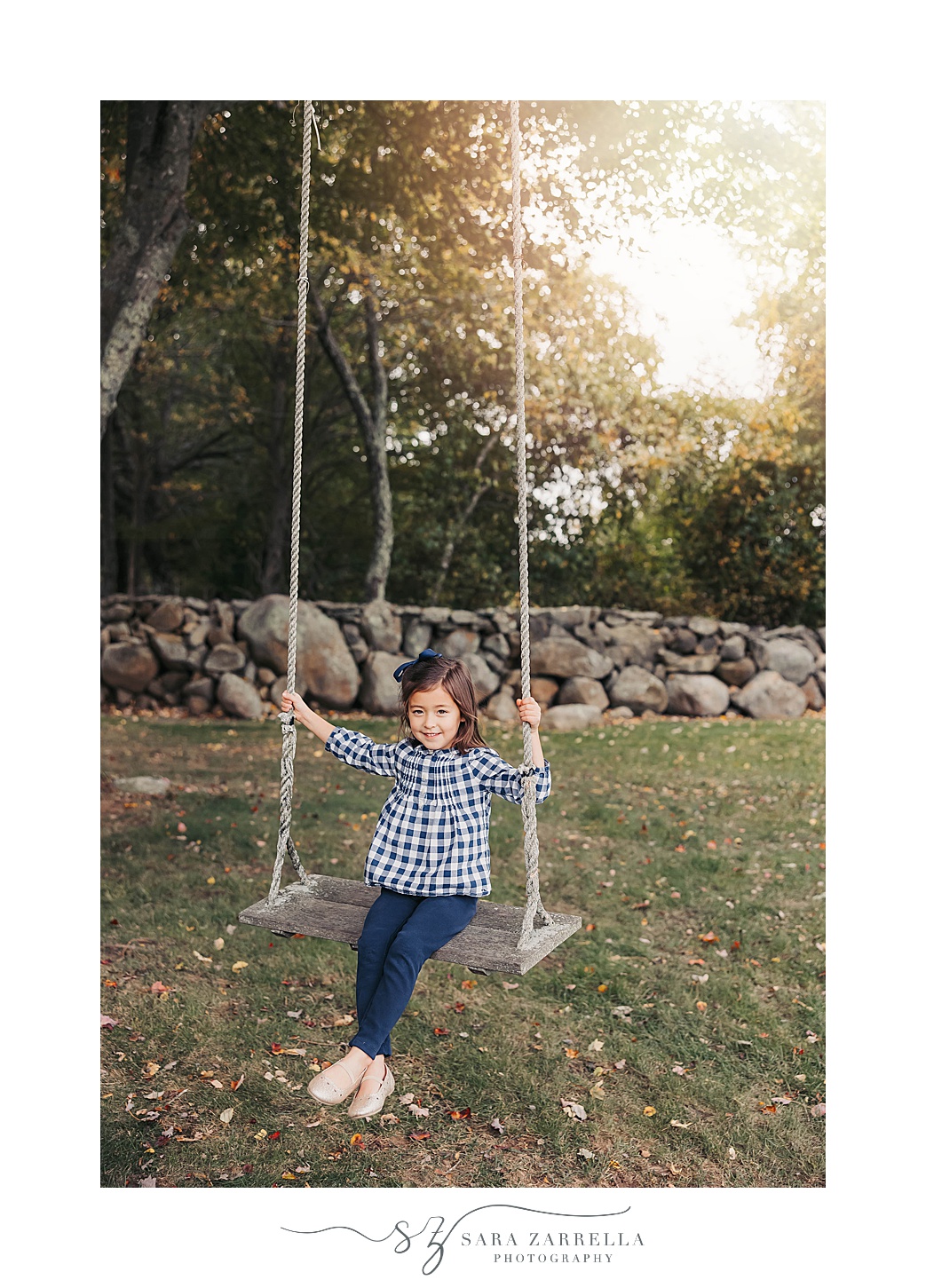 toddler swings on wooden swing as sun sets on Rhode Island farm