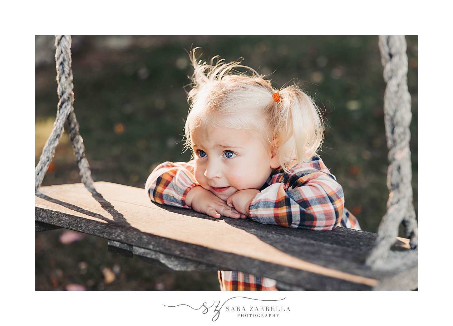 blonde girl leans on wooden swing during fall mini sessions 