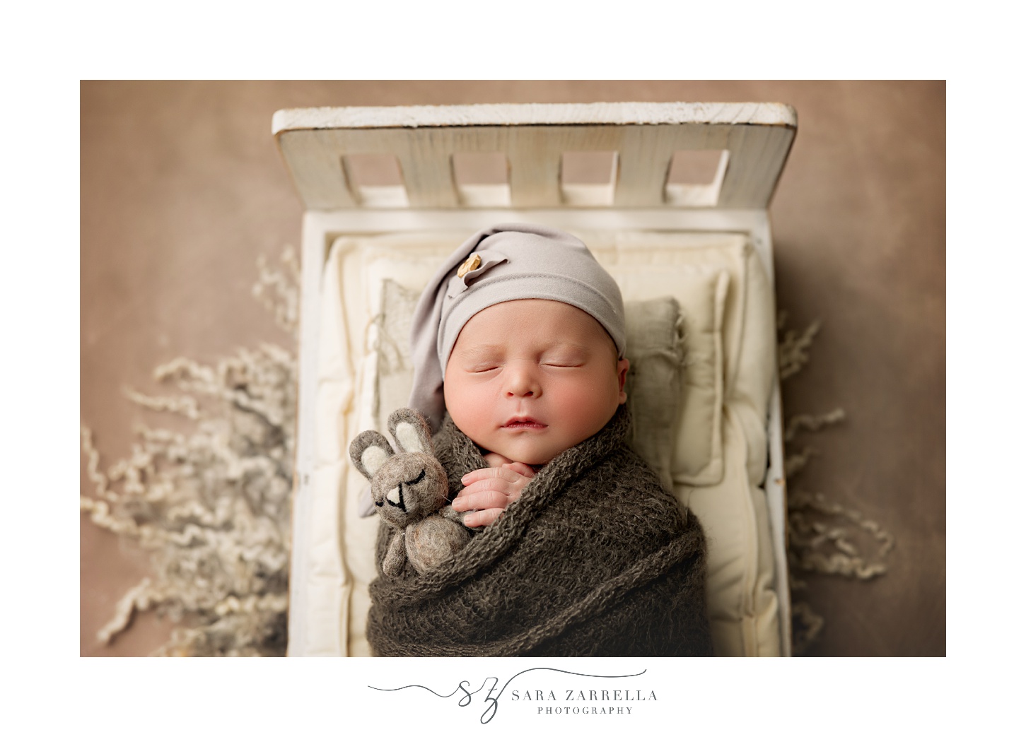 baby lays on wooden bed during newborn session with Rhode Island newborn and family photographer Sara Zarrella Photography