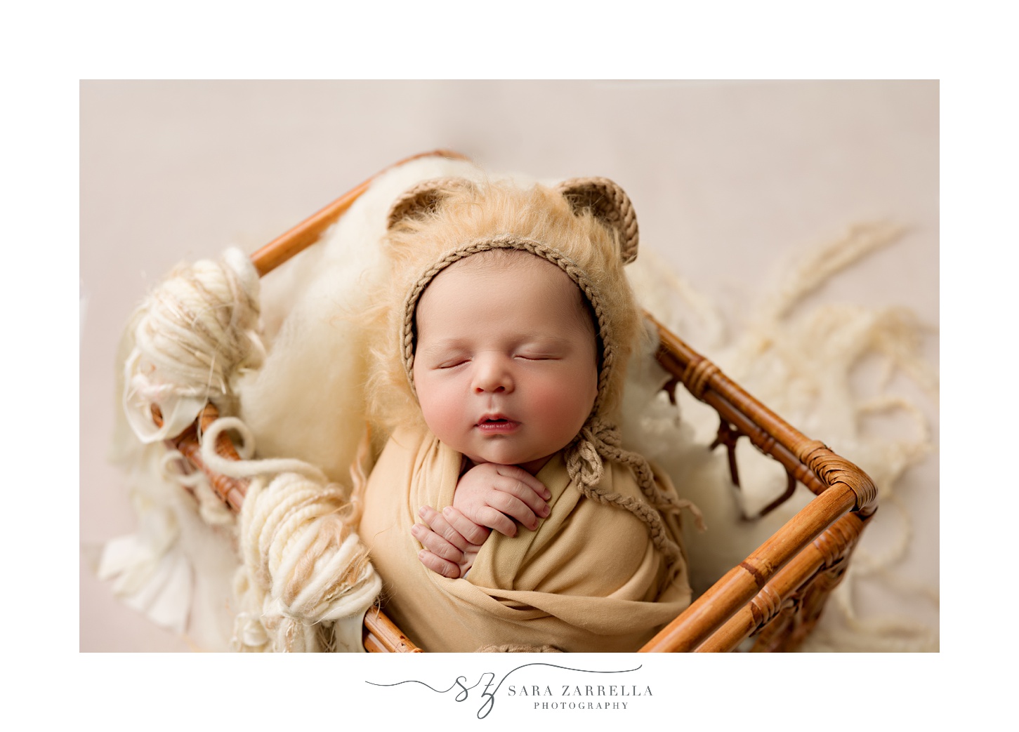 baby in neutral outfit lays in wooden crib during newborn session with Rhode Island newborn and family photographer Sara Zarrella Photography